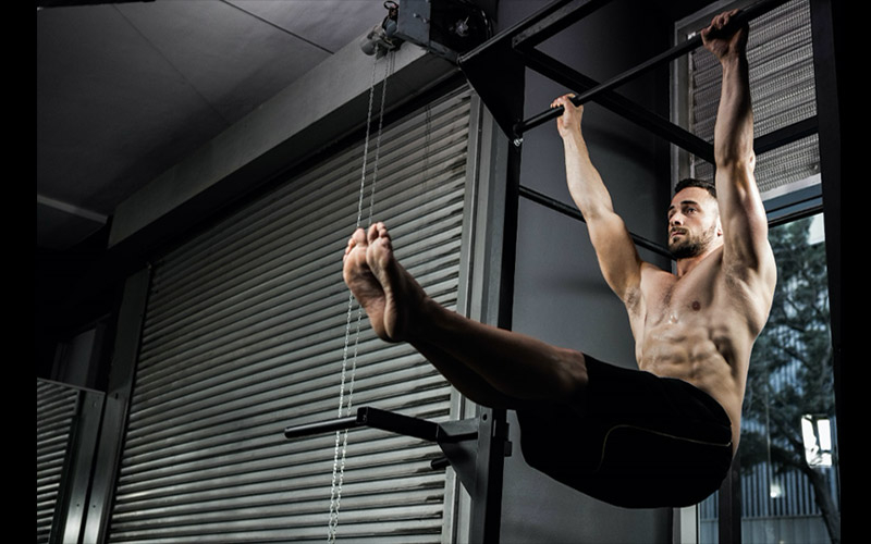 7 Different Pull-Up Bar Exercises You Can Do With Nothing But a Bar